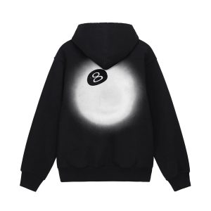 A black Stussy hoodie worn under an orange 8 Ball Sherpa jacket on a dark Halloween street.